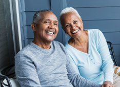 Photo of a man and woman smiling. 