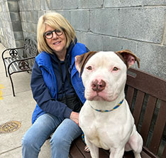 Photo of a woman and a dog. Link to What to Give.